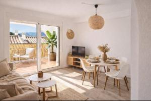 a living room with a table and a tv at Casa MuMa in Calpe