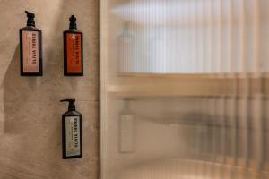 two bottles hanging on a wall next to a window at Karavel Suites - Old Town Boutique Rooms in Rhodes Town +17 photos