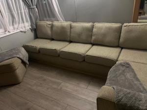 a couch sitting in a living room next to a window at Millfields caravan park I9 in Skegness +1 photo