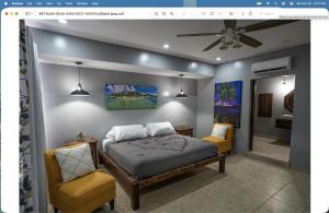 a bedroom with a bed and two chairs at mame trees in West End