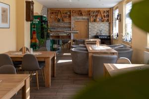 a restaurant with tables and chairs and a bar at Ferienhaus Enessa in Lauchhammer +18 photos