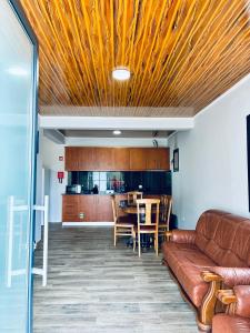 a living room with a couch and a table at Seaside & Levada Escape in Machico