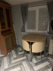 a kitchen with a table and two chairs and a window at Millfields caravan park I9 in Skegness