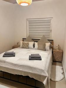 a bedroom with a large bed with two pillows on it at Ammersee Garten Appartment in Herrsching am Ammersee