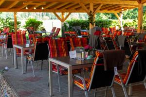 a group of tables and chairs under a pavilion at Ferienhaus Enessa in Lauchhammer