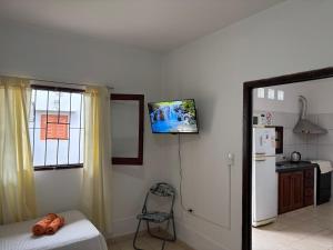 a kitchen with a bed and a tv on the wall at Tu casa en Ruta 34 - Wifi - Cochera -5 personas in Fernández