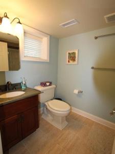 a bathroom with a white toilet and a sink at Broadway Beach Retreat Unit 4 in Cape May +11 photos