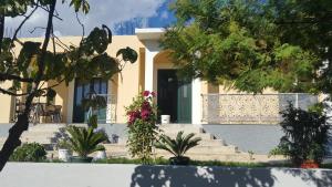 a house with a green door and some plants at Gloria Apartments in Herceg-Novi