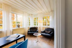 a living room filled with furniture and a window at Hotel Skeppsholmen, a Member of Design Hotels™ in Stockholm