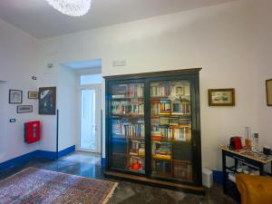 a room with a book shelf filled with books at Affitta camere ALMA MATER in Castrignano del Capo +22 photos