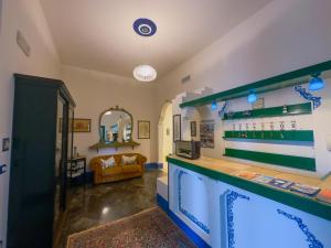 a room with a bar with a couch in the background at Affitta camere ALMA MATER in Castrignano del Capo