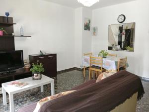 a living room with a couch and a table at Alejandra in Armilla