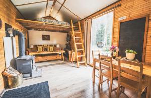 a room with a stove and a table and a classroom at Goonieland Backcountry Sauna & Stays in Golden