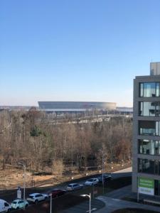 a view of a parking lot with a building in the background at Sunset Terrace Wrocław Stadion in Wrocław
