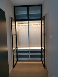 a room with a closet with a glass door at Sunset Terrace Wrocław Stadion in Wrocław