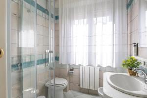a bathroom with a toilet and a sink and a shower at Affittacamere 2 Prima Fila Mare in Porto Recanati +23 photos