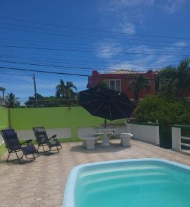 a patio with a table and chairs and an umbrella at Pascall's Luxury Homes Villa in Lambeau +10 photos