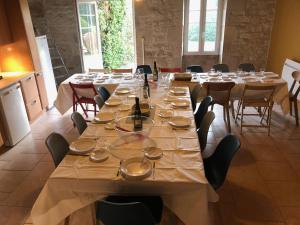 a large dining room with a long table and chairs at Le Pistoulet Gîte in Doeuil-sur-le-Mignon