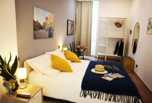 a bedroom with a bed with a hat on it at Fortuna Guest House - Charm & Relax rooms in Syracuse +122 photos