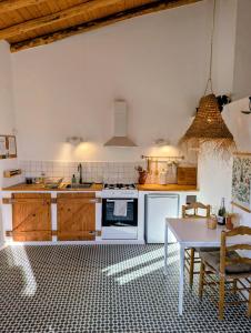 a kitchen with a stove and a table in it at Finca Bravo in Cortegana