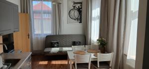 a small kitchen with a table and chairs and a couch at Apartmány Šrámek Stříbro in Stříbro