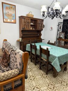 a dining room with a table and a piano at Miami-Playa in Miami Platja