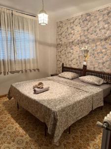 a bedroom with two beds and a stone wall at Miami-Playa in Miami Platja +40 photos