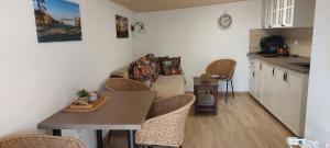 a kitchen and dining room with a table and chairs at Apartmán U Lípy Janovičky in Heřmánkovice