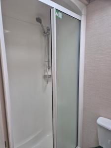 a shower with a glass door in a bathroom at Tower View Retreat, Haven Marton Mere in Blackpool +21 photos