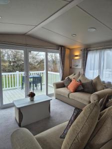 a living room with a couch and a table at Tower View Retreat, Haven Marton Mere in Blackpool