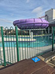 a pool with a purple inflatable raft on a fence at Tower View Retreat, Haven Marton Mere in Blackpool