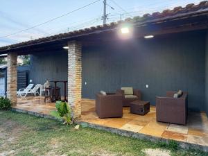 a patio with couches and chairs on a house at Paracas House in Paracuru