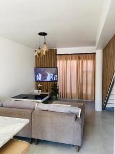 a living room with a couch and a tv at Lagoon Staycation in Walvis Bay