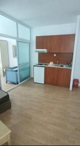 an empty room with a kitchen and a large room with at Apartment in Primorsko Del Sol in Primorsko