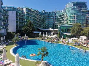 a large swimming pool in front of a large building at Apartment in Primorsko Del Sol in Primorsko