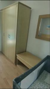 a room with a bench and a cabinet and a mirror at Apartment in Primorsko Del Sol in Primorsko