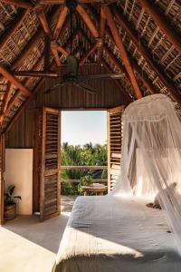 a bedroom with a bed in a wooden house at Casa Chula Hotel Boutique Frente al Mar in Tierra Blanca