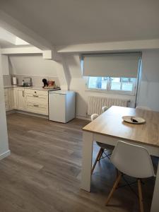 a kitchen with a table and chairs in a room at Apartamentos Demar Luis Casais in O Grove +40 photos