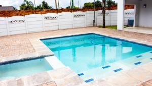 a swimming pool with blue water in a yard at Phela Guesthouse in Edenvale