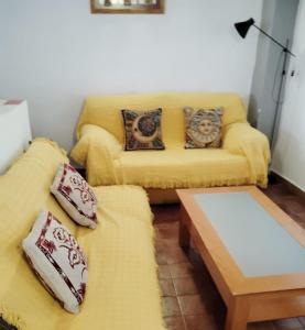 a living room with two couches and a coffee table at Casa La Abuela 1982 in La Iruela