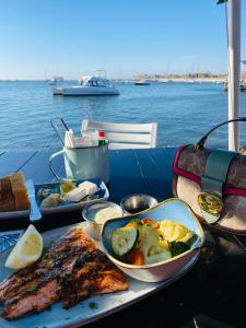 a table with a plate of food on a boat at Lagoon Staycation in Walvis Bay