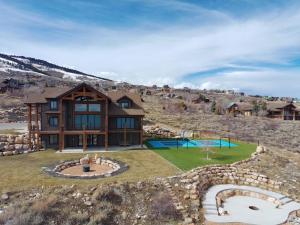 an image of a large house with a landscaping at Raspberry Ridge Lodge in Fish Haven