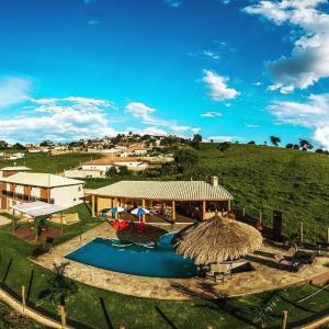 an aerial view of a resort with a pool and a hut at Pousada Morada do Sol in Socorro