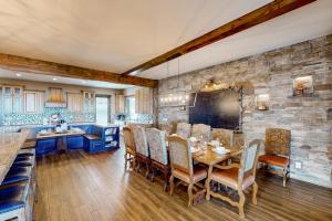 a kitchen and dining room with a table and chairs at Raspberry Ridge Lodge in Fish Haven