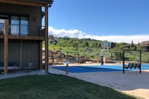 a basketball court in front of a house at Raspberry Ridge Lodge in Fish Haven