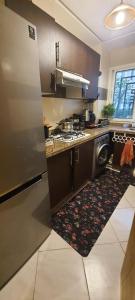 a kitchen with a stainless steel refrigerator and a rug at Cozy appt in Casablanca