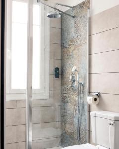 a bathroom with a shower with a toilet at La Villa Rose-Marie in Saint-Brevin-les-Pins +21 photos