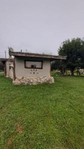 a small building with a window in a field at Biocasa in Villa Anizacate +2 photos