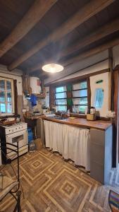 a kitchen with a table and a stove in it at Biocasa in Villa Anizacate