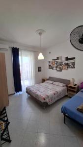 a bedroom with a bed and a large window at Buonviaggio in La Spezia